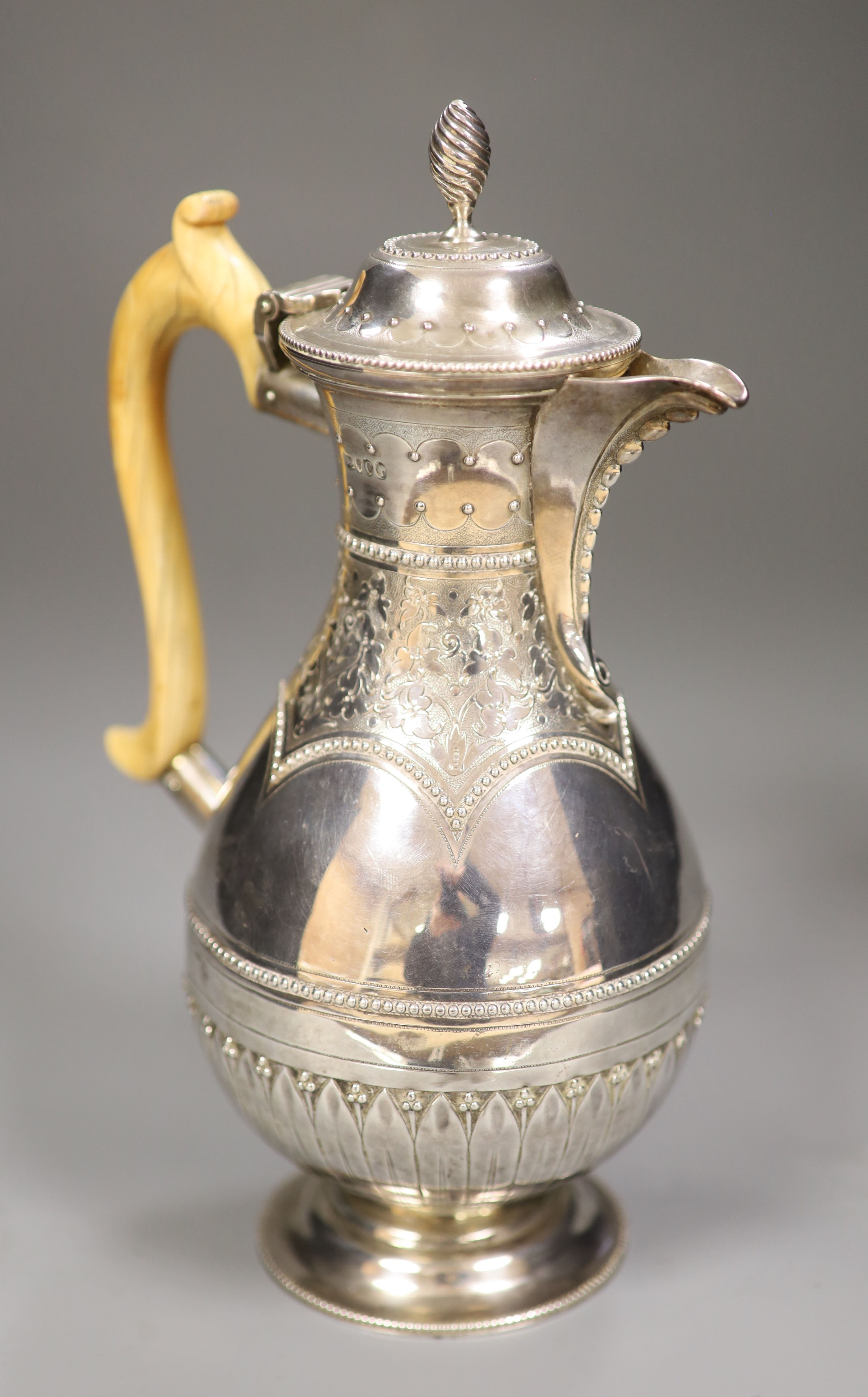 A Victorian silver baluster hot water pot, Henry Holland, London, 1878, with ivory handle, height 23.8cm, gross 15oz.